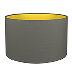 A charcoal grey drum lampshade with gold lining