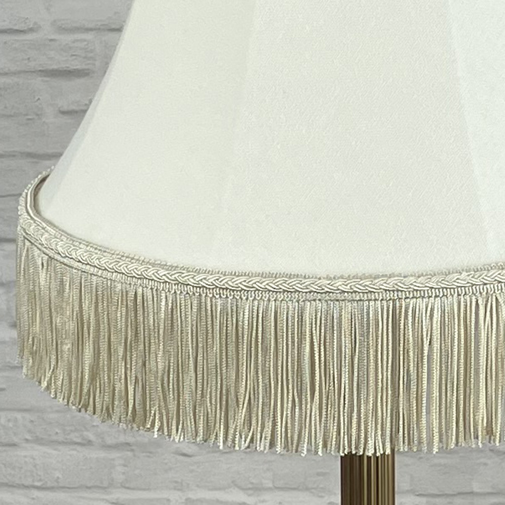 cream bowed empire lampshade with fringe switched off