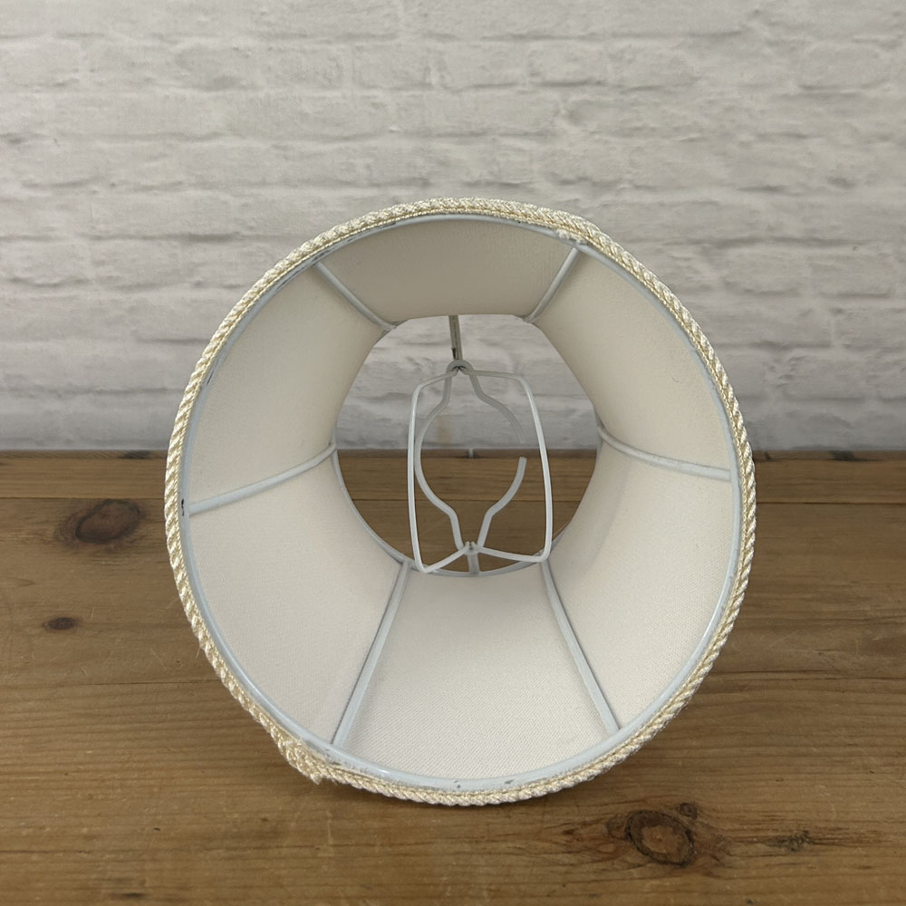 Interior view of bowed chandelier shade showing clip-on bulb fitting and curved internal frame