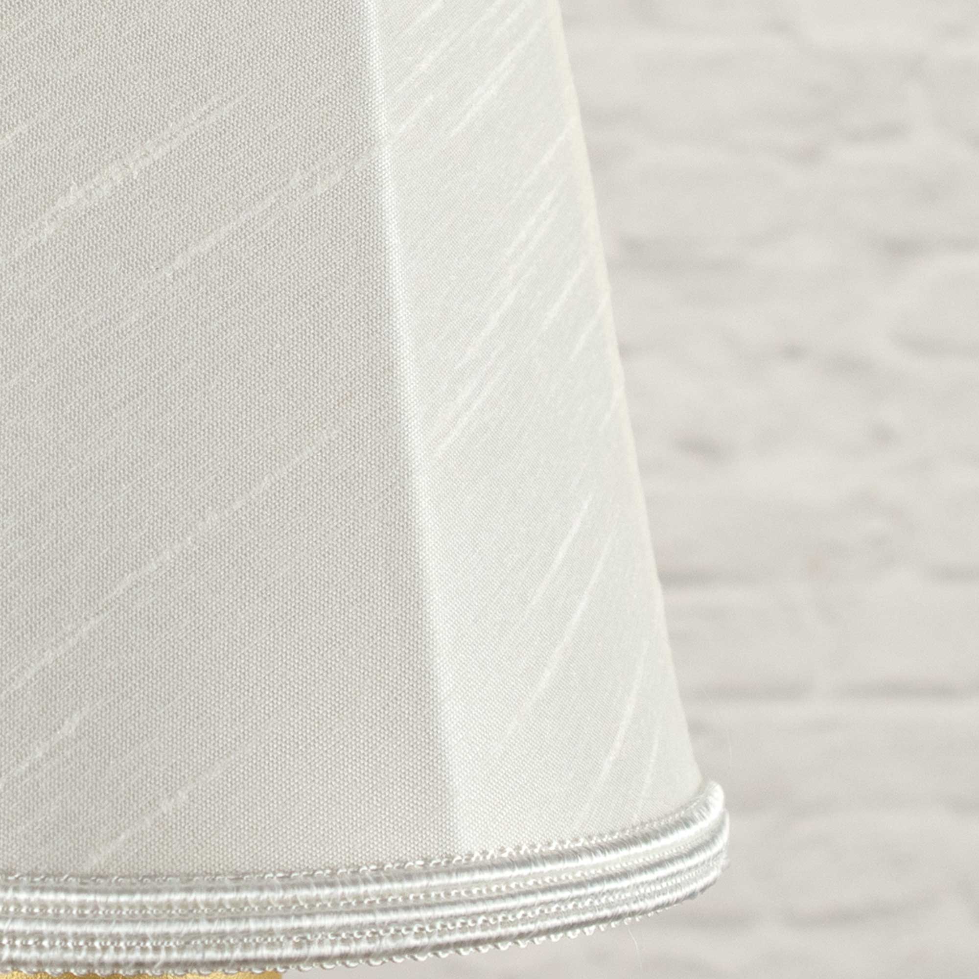 Close-up of white faux silk fabric showing dupion slub texture on empire chandelier shade