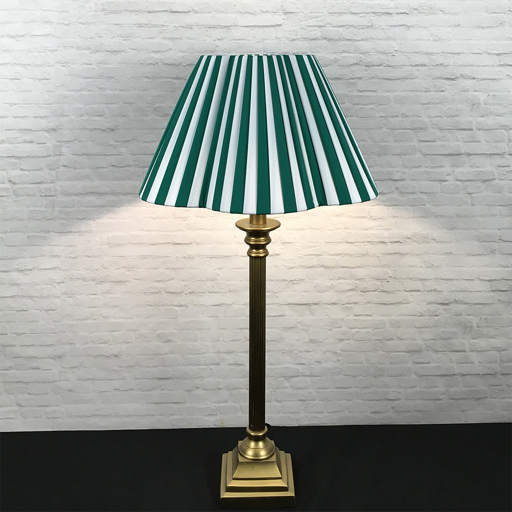 Green and white striped daisy pleated lampshade on a table lamp base