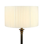 A cream knife pleated drum lampshade on table lamp