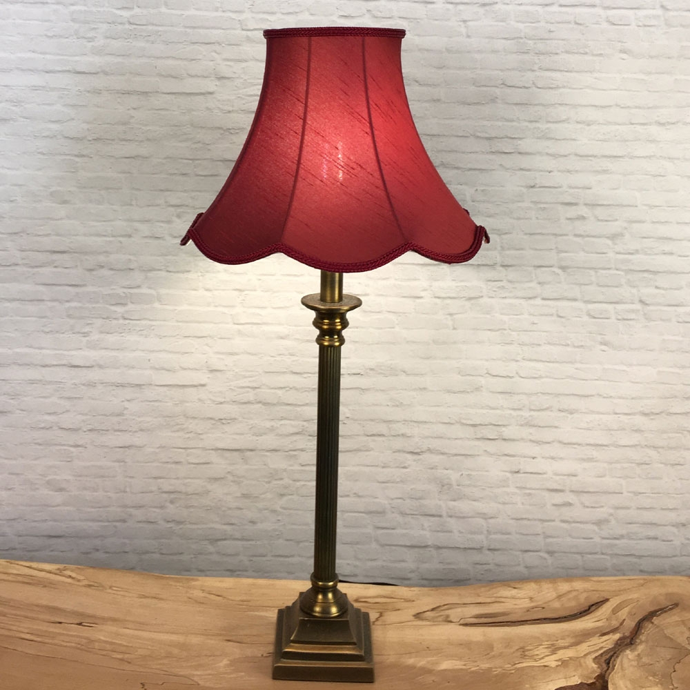 Complete Image of a Ruby Scalloped Lampshade on a Table lamp switched on