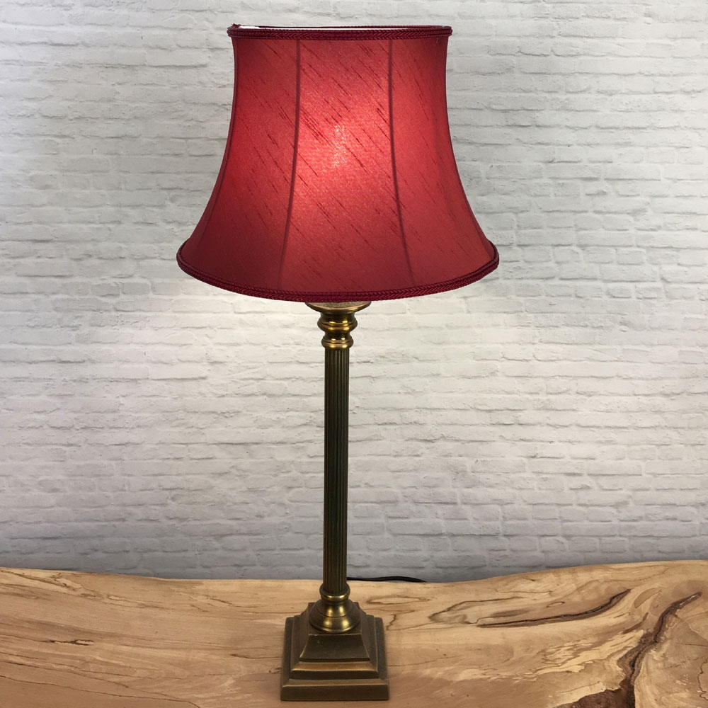 Complete image of a traditional Bowed Drum Table Lampshade in our Ruby Faux Silk with a Matching Burgundy Rope Trim. Switched On