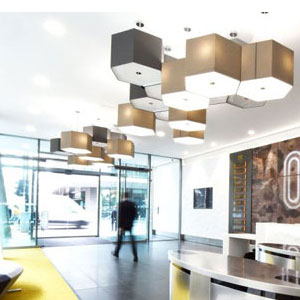 Bespoke Octagons A cluster of taupe and charcoal hexagonal lampshades in a commercial setting