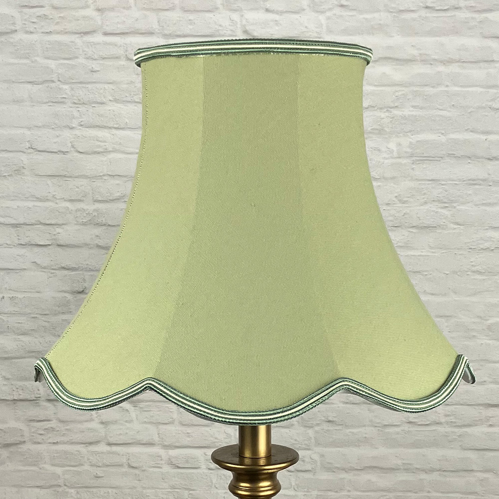 Green Scalloped Lampshade on a Floor lamp switched off