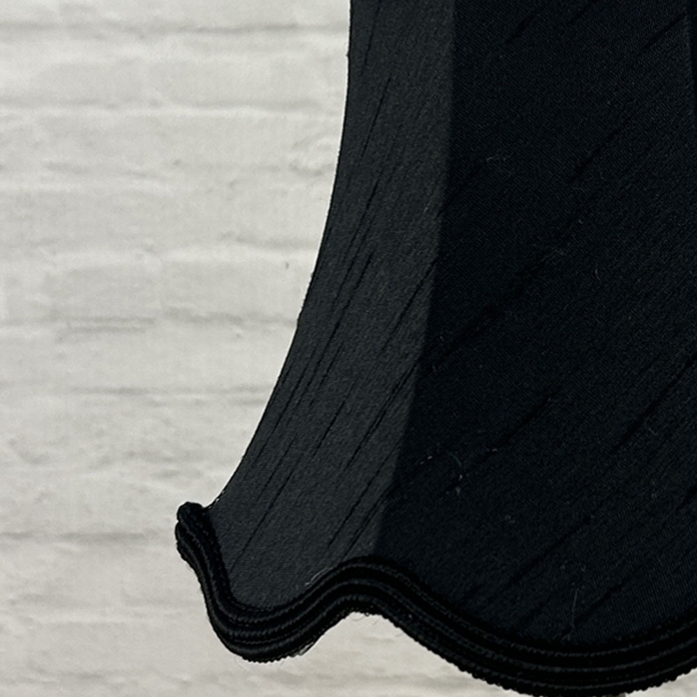 Close-up of black faux silk scalloped chandelier shade with matching soutache trim