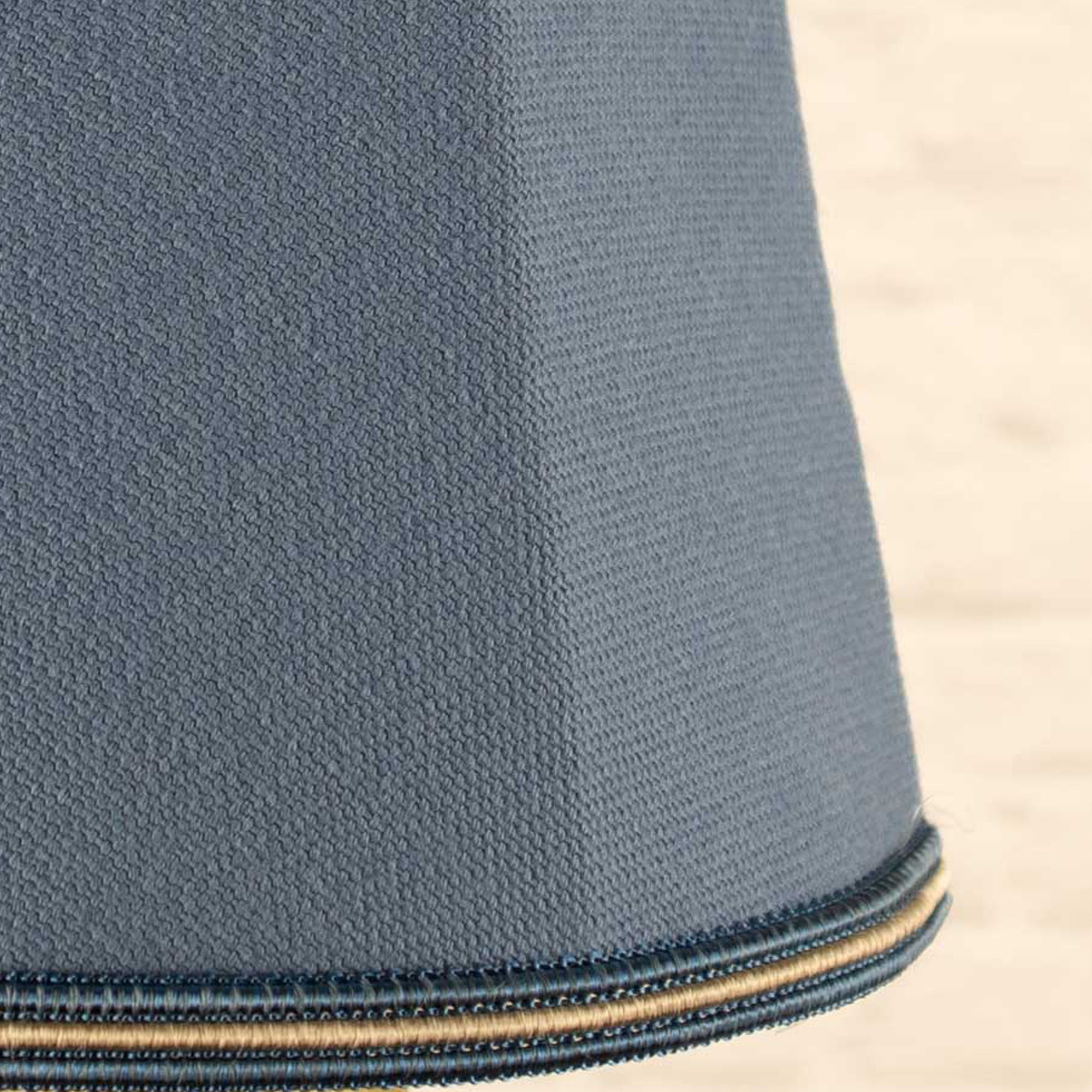 Close-up of blue brushed cotton fabric and blue and fawn soutache trim on empire candle shade
