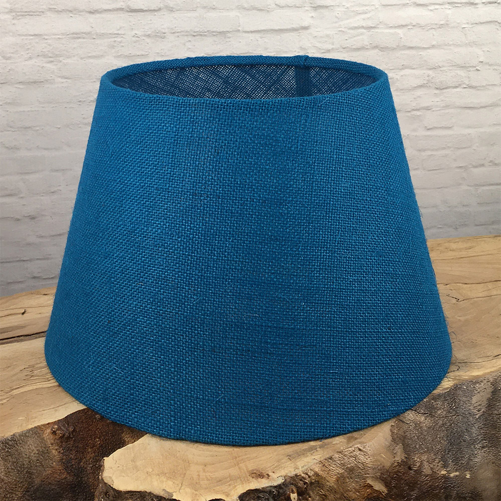 Blue hessian tapered drum lampshade styled in a modern interior setting