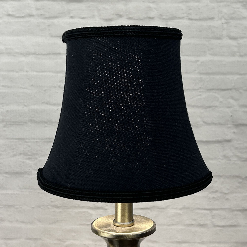 Black bowed chandelier shade in brushed cotton lit showing warm glow and black soutache trim