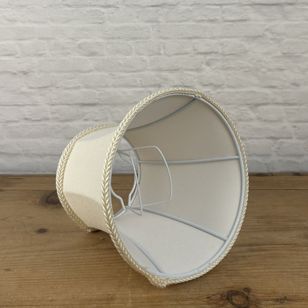 Angled interior view of cream brushed cotton bowed chandelier shade with rope trim