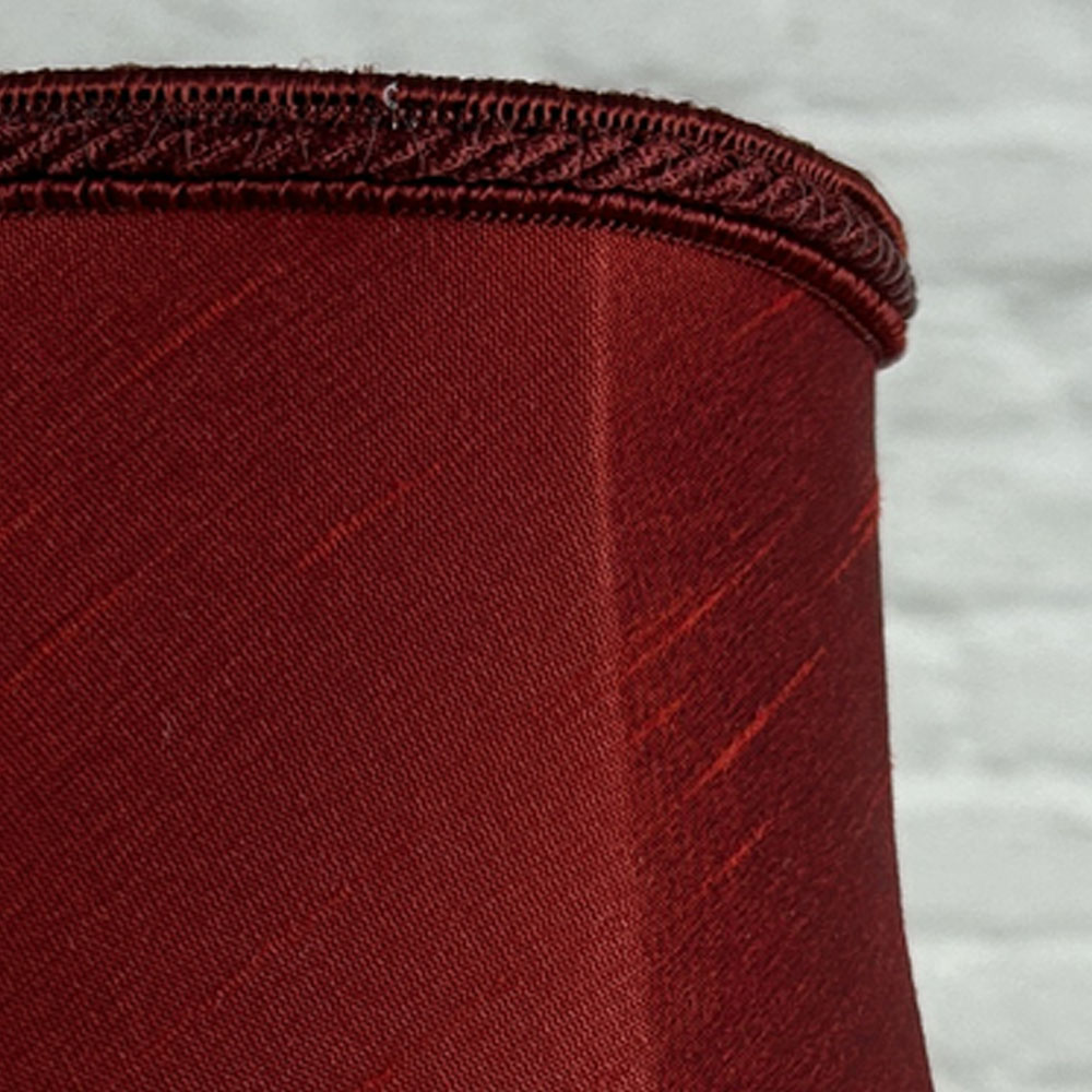 Close-up of burgundy faux silk bowed chandelier shade with rope trim