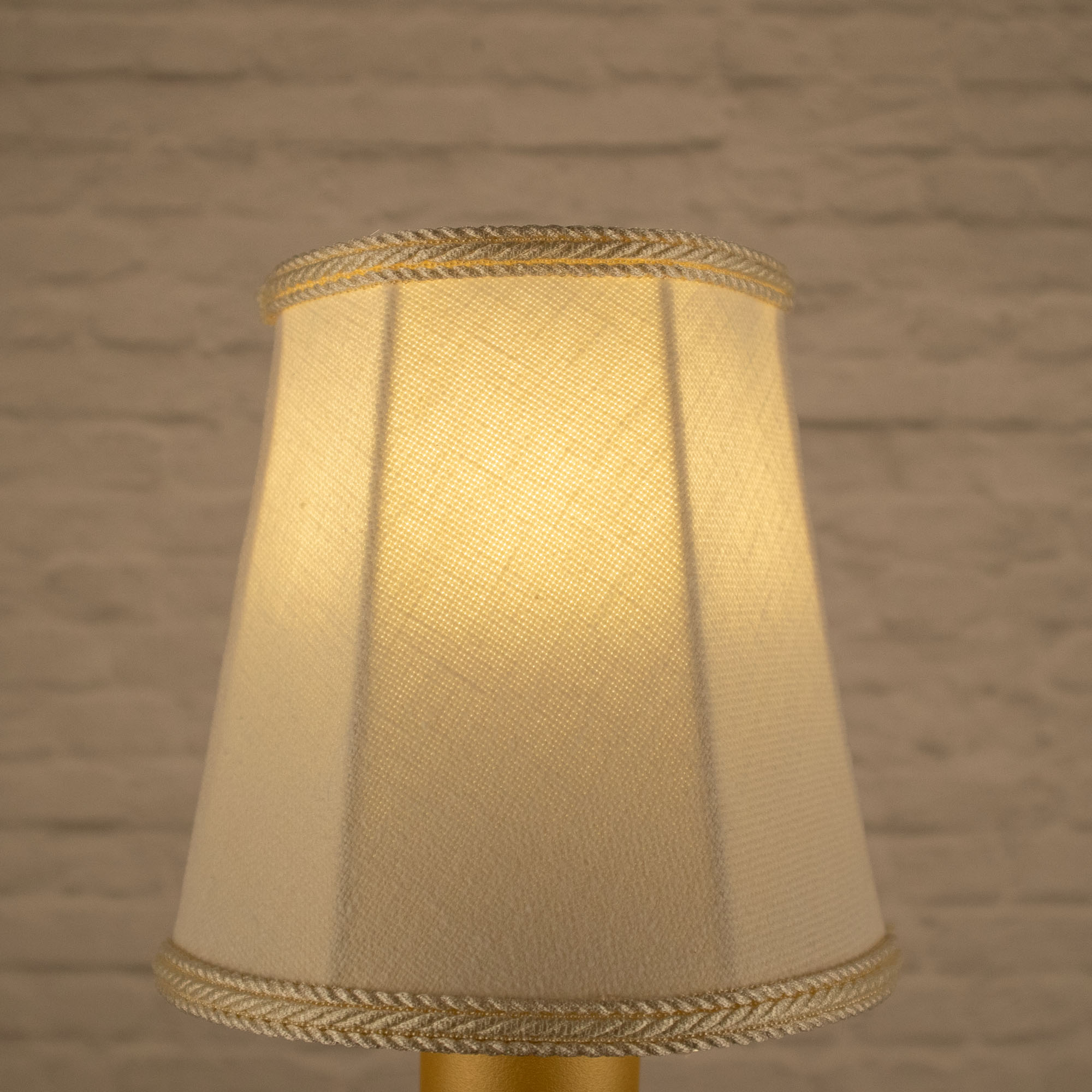 Lit cream empire brushed cotton candle shade with matching rope trim