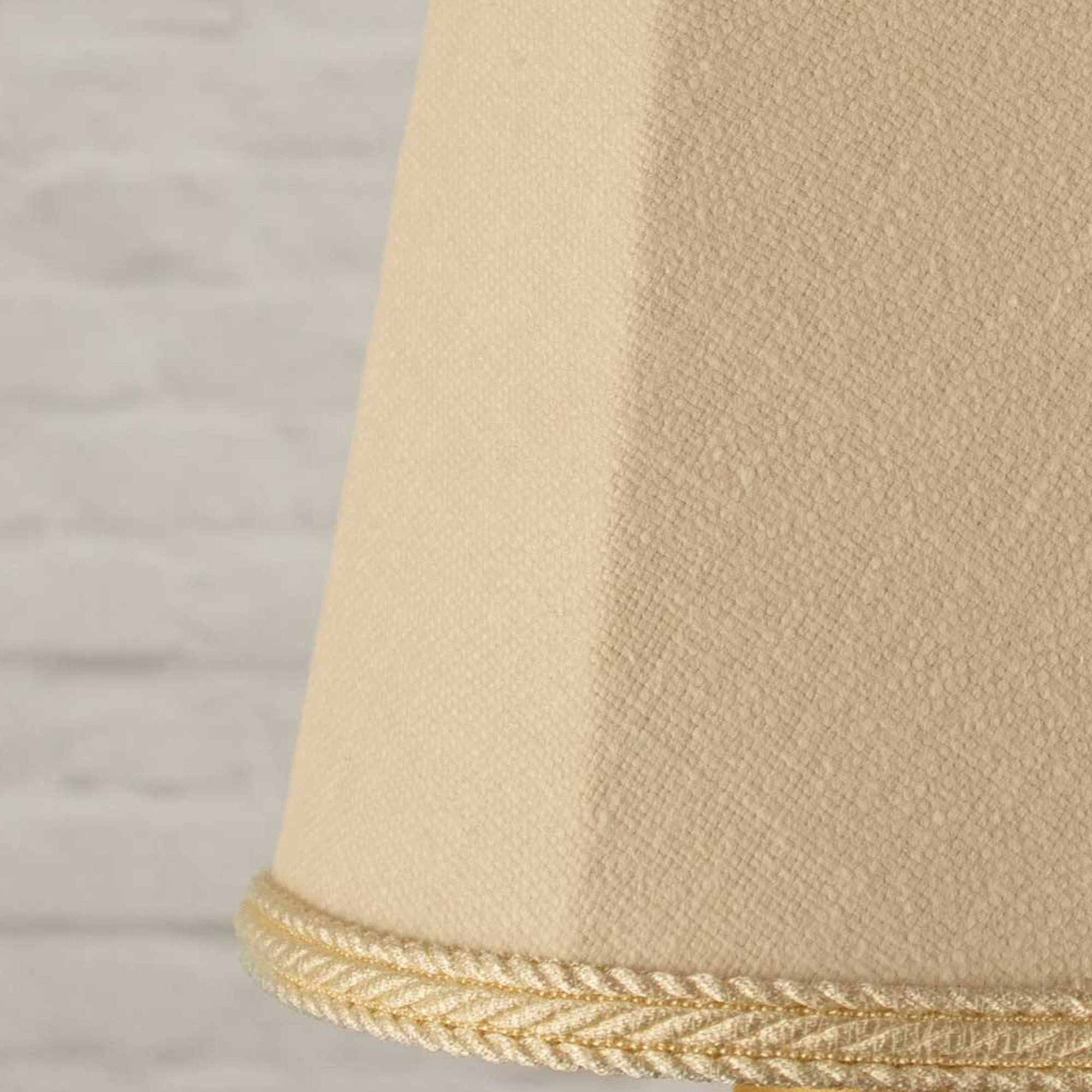 Close-up of cream brushed cotton fabric and matching rope trim on empire candle shade