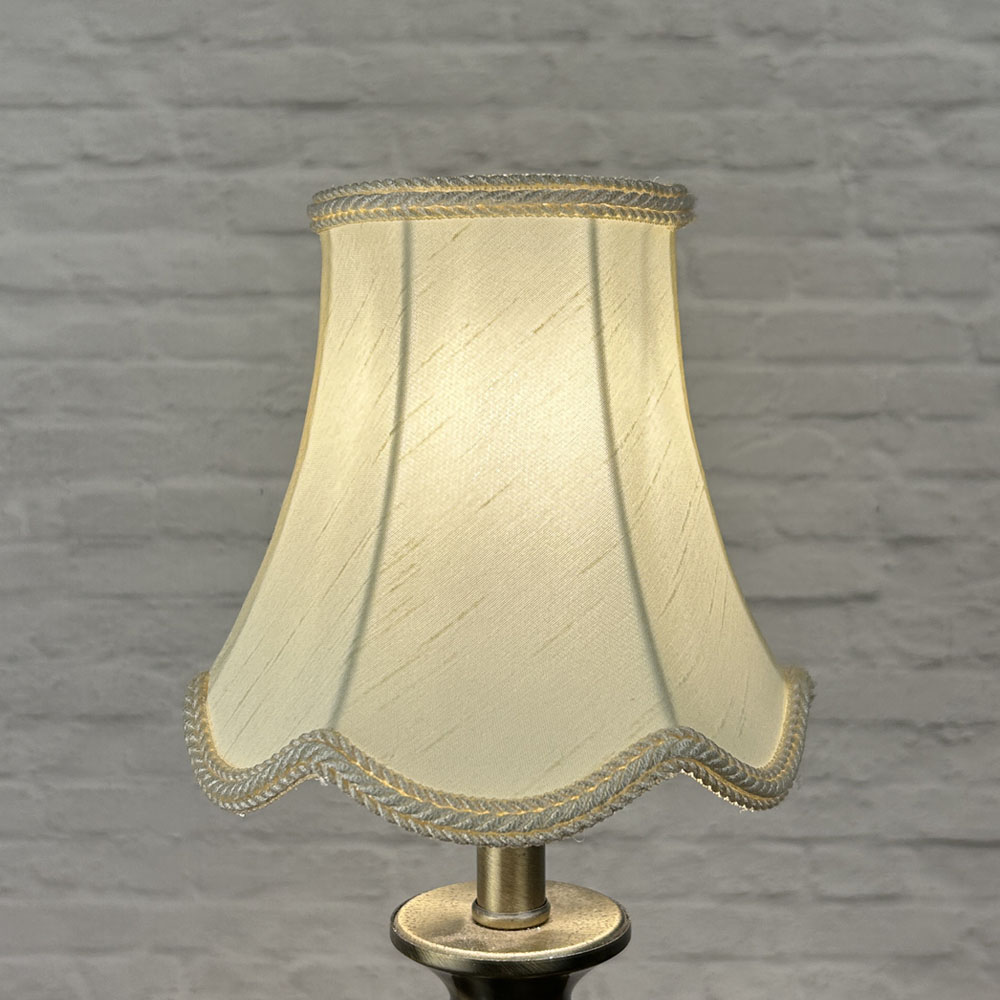 Cream scalloped chandelier shade in faux silk lit showing warm glow and rope trim