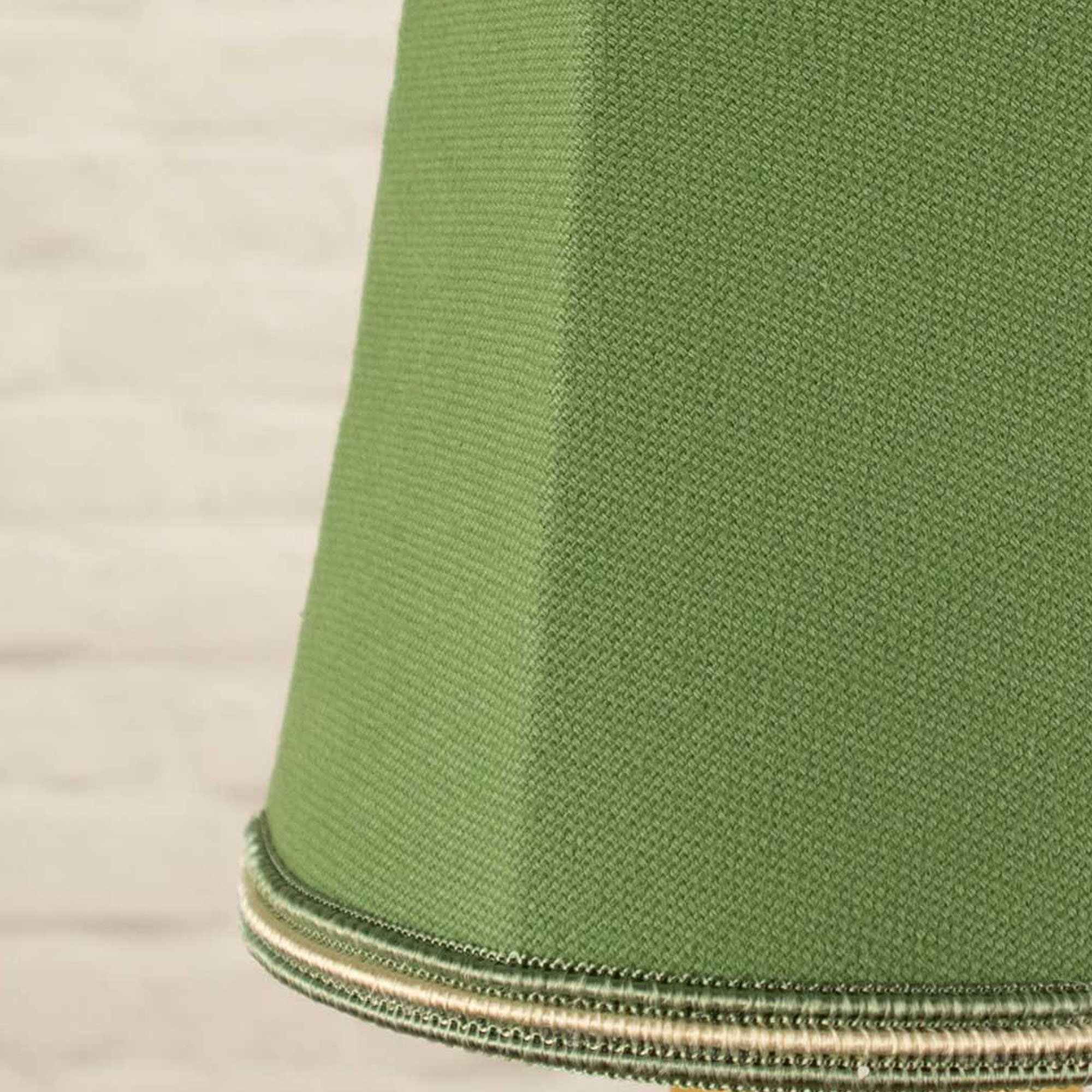 Close-up of green brushed cotton fabric and green and fawn soutache trim on empire candle shade