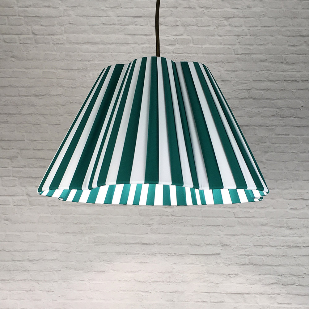 Green and white striped daisy pleated lampshade hanging as a ceiling pendant