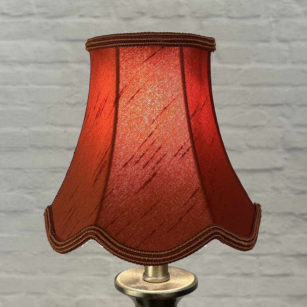Terracotta scalloped chandelier shade in faux silk lit showing warm earthy tone and soutache trim