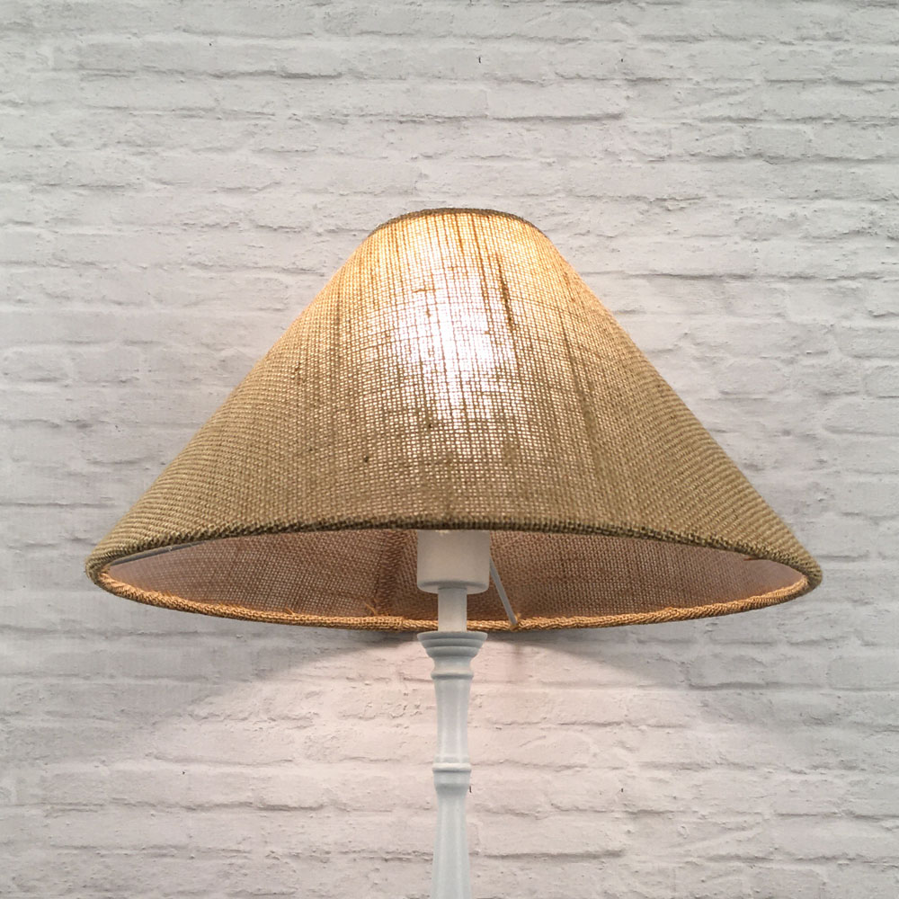 natural hessian coolie on a standing lampshade lit