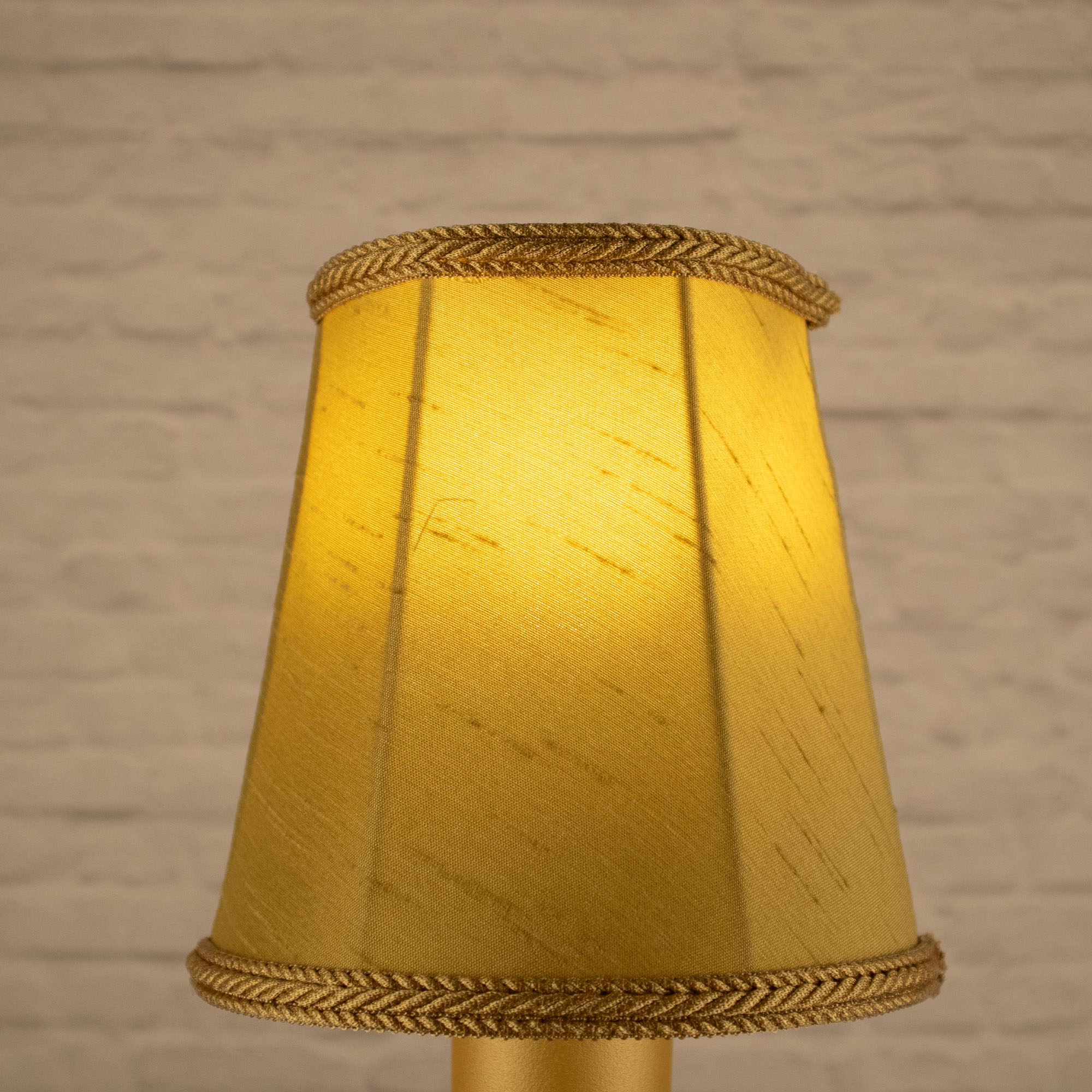 Lit old gold empire faux silk chandelier shade with matching rope trim