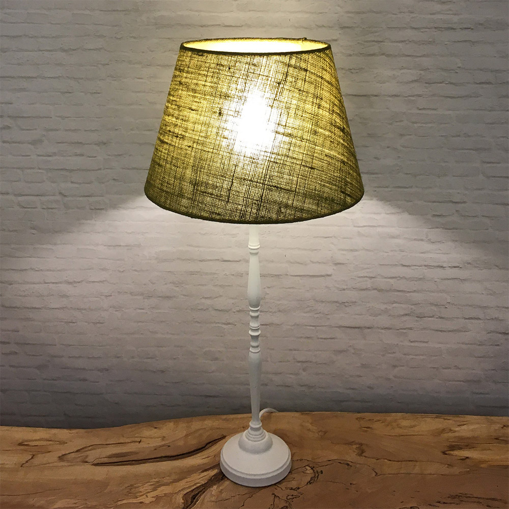 Olive green hessian lightshade on table lamp in low light