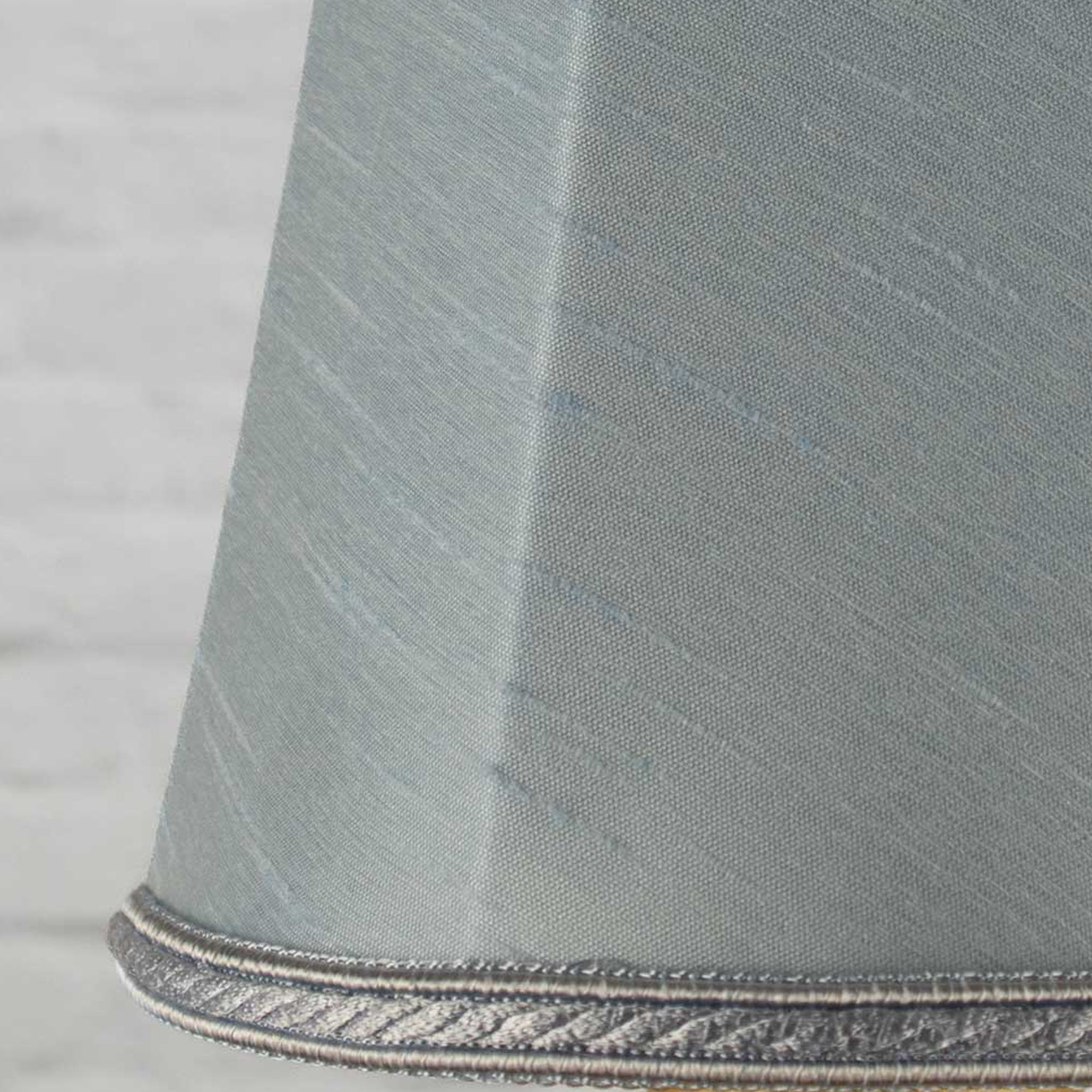 Close-up of pale blue faux silk fabric showing dupion slub texture on empire chandelier shade