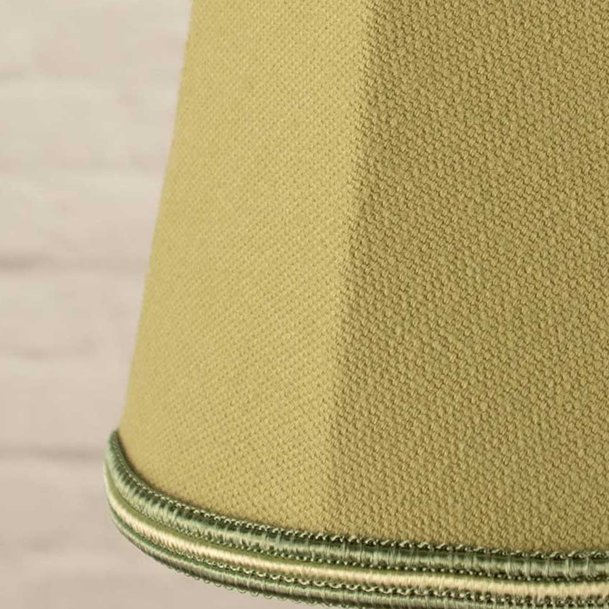 Close-up of pear brushed cotton fabric and green and pear soutache trim on empire candle shade