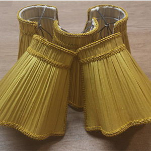Lampshade recovering - after- Five recovered lampshades in gold pleat