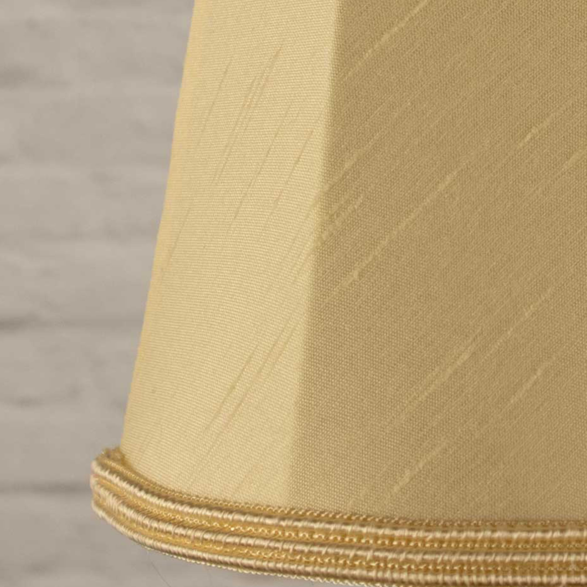 Close-up of cream faux silk fabric showing dupion slub texture on empire chandelier shade