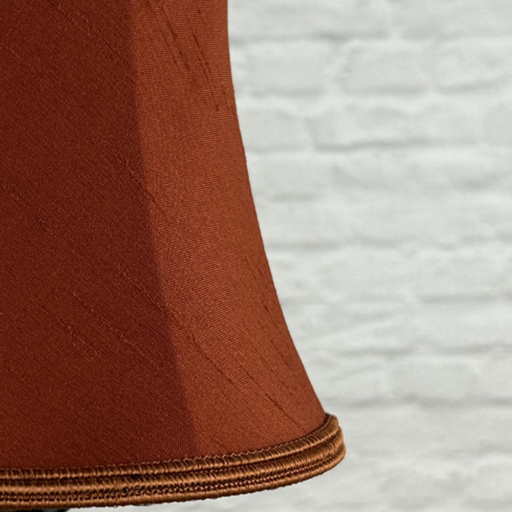 Close-up of terracotta faux silk bowed chandelier shade with soutache trim