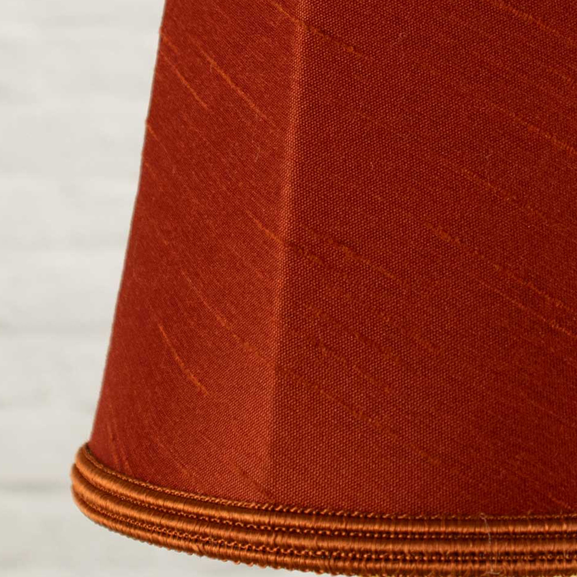 Close-up of terracotta faux silk fabric showing dupion slub texture on empire chandelier shade