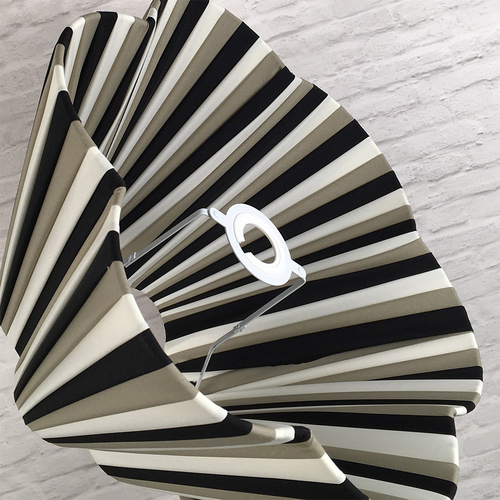 Tri-stripe daisy pleated lampshade styled in an interior setting