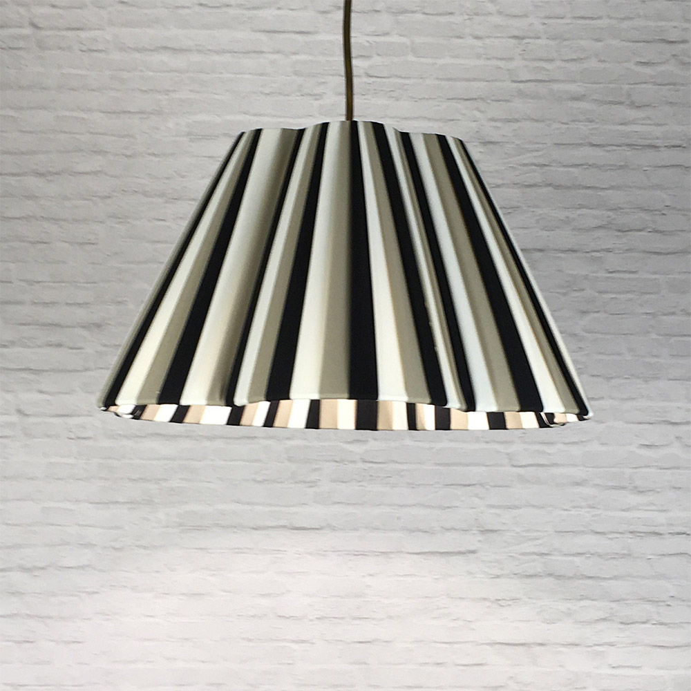Tri-stripe daisy pleated lampshade hanging as a ceiling pendant
