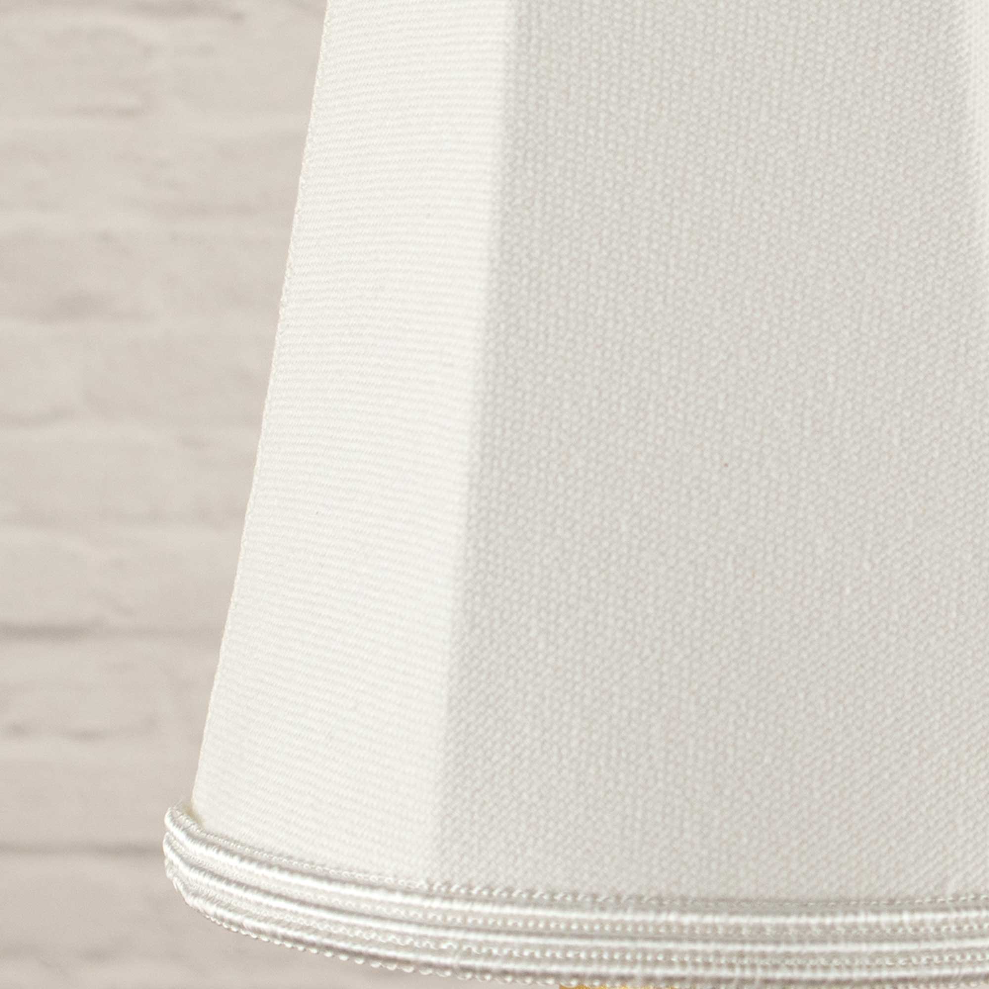 Close-up of white brushed cotton fabric and matching soutache trim on empire candle shade