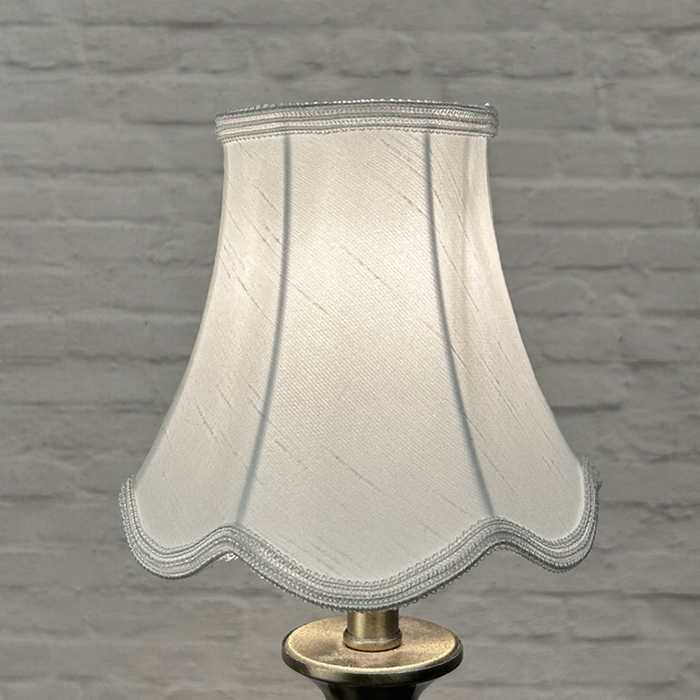 White scalloped chandelier shade in faux silk lit showing soft glow and matching soutache trim