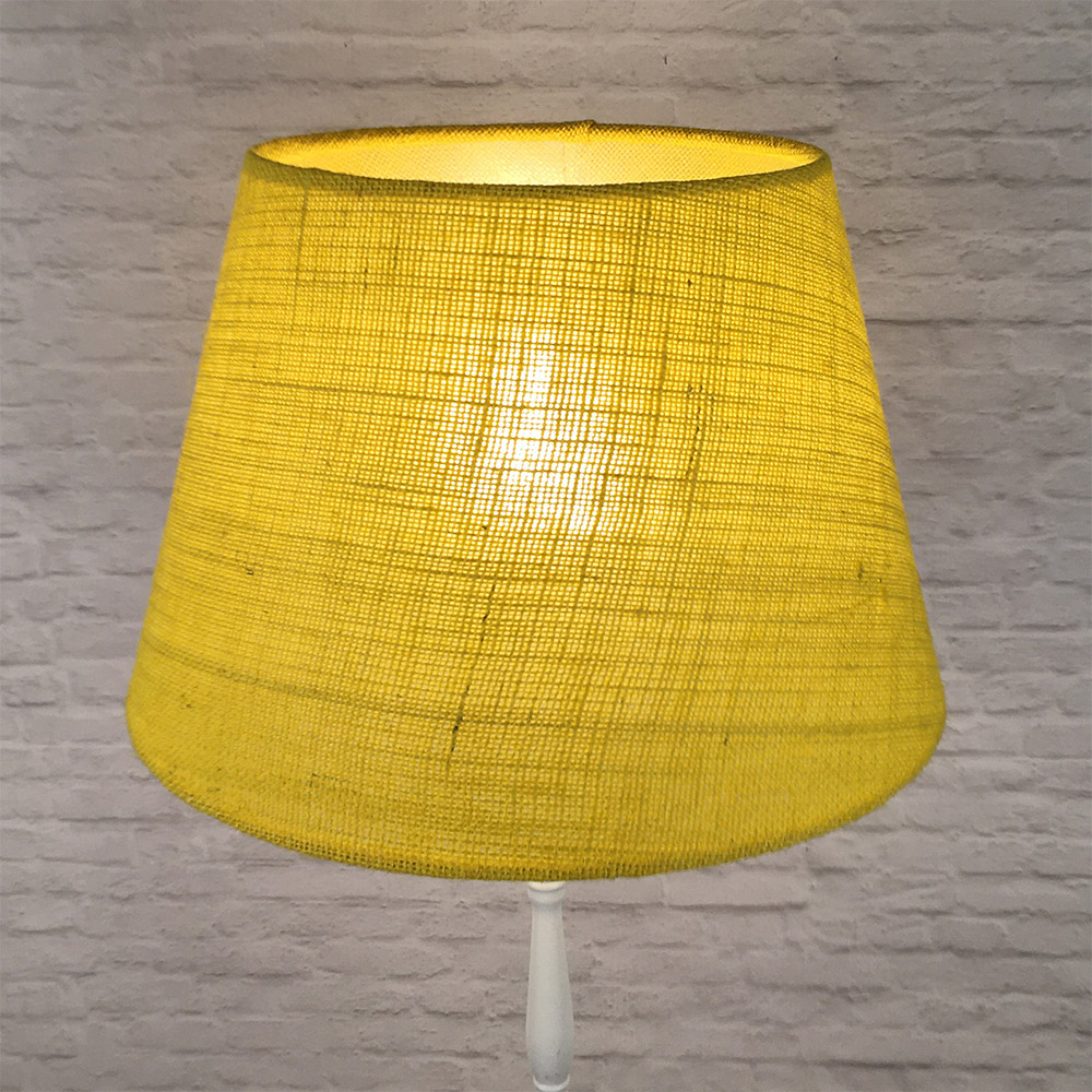 Yellow hessian lampshade on floor lamp